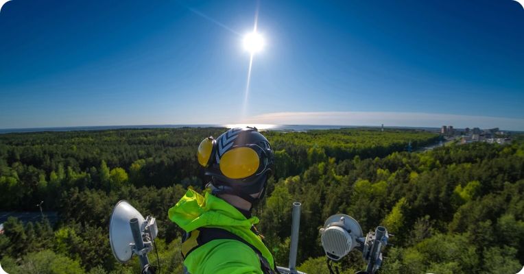 construction worker looking over forest area