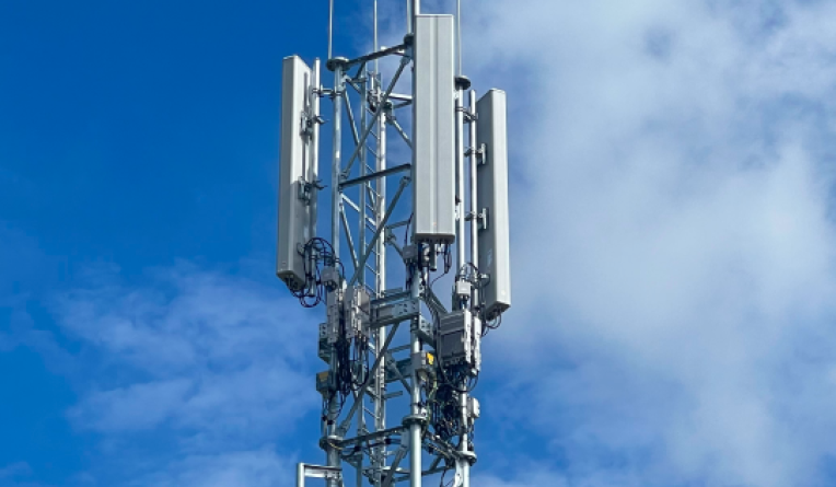 Telecoms tower next to a tennis court